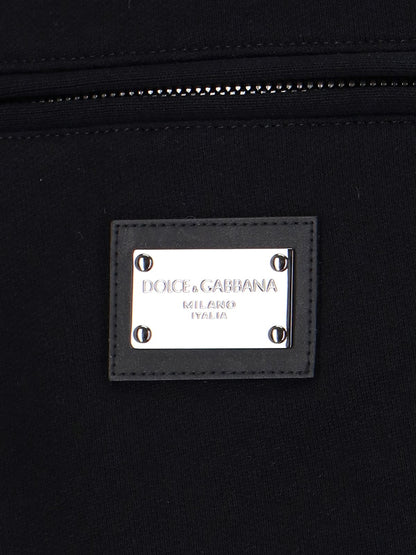 Dolce & Gabbana Pantaloncini sportivi-Short-Dolce & Gabbana-Pantaloncini sportivi Dolce & Gabbana, in cotone nero, vita elastica, coulisse, due tasche zip laterali, una tasca zip retro, placca logo metallico argentato retro, orlo dritto.-Dresso