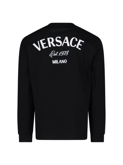 Versace T-Shirt "Milano stamp"-t-shirt maniche lunghe-Versace-T-shirt "Milano stamp" Versace, in cotone nero, girocollo, ricamo logo bianco fronte e retro, polsini a costine, orlo dritto.-Dresso
